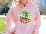 Person wearing a pink hoodie with a Christmas-themed graphic design.