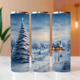 Three cylindrical tumblers with winter scene designs on a marble surface.