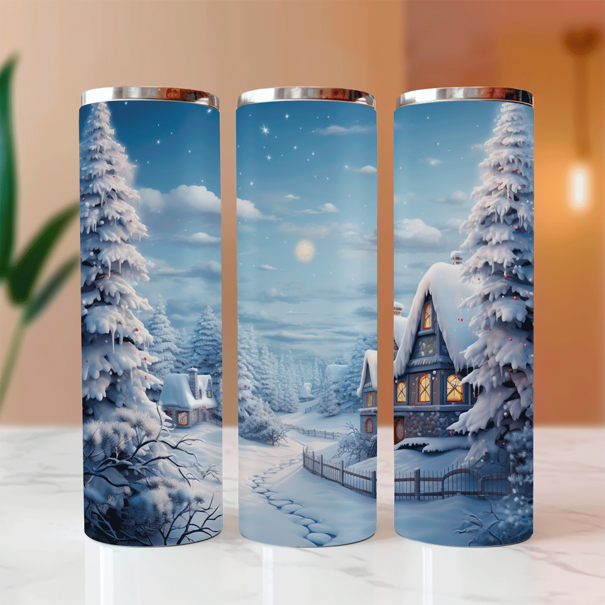 Three tumblers with a winter scene design featuring snow-covered trees and houses.