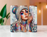 Three tumblers with artistic designs of a woman with colorful makeup and tattoos on a white surface.