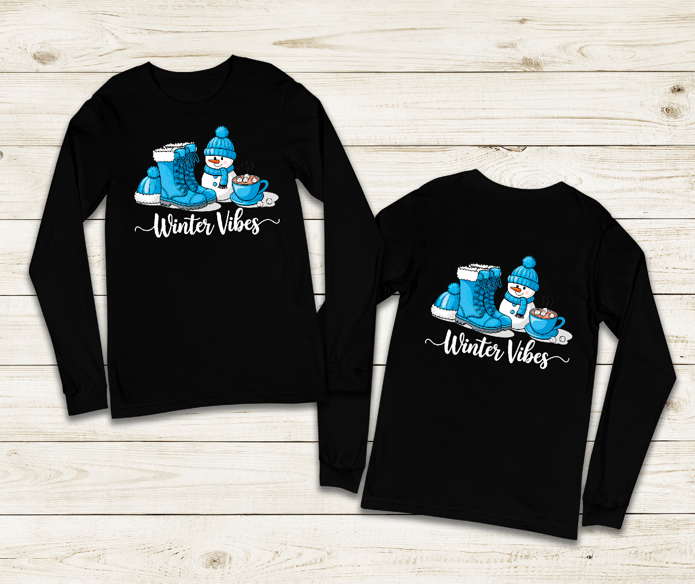 Two black long-sleeve shirts with winter-themed design on a wooden surface