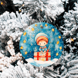 Decorative Christmas ornament with a child holding a gift, hanging on a snow-covered tree.