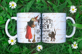 Witch-themed mug with 'Witch's Brew Tea Company' text on a grassy background with daisies.