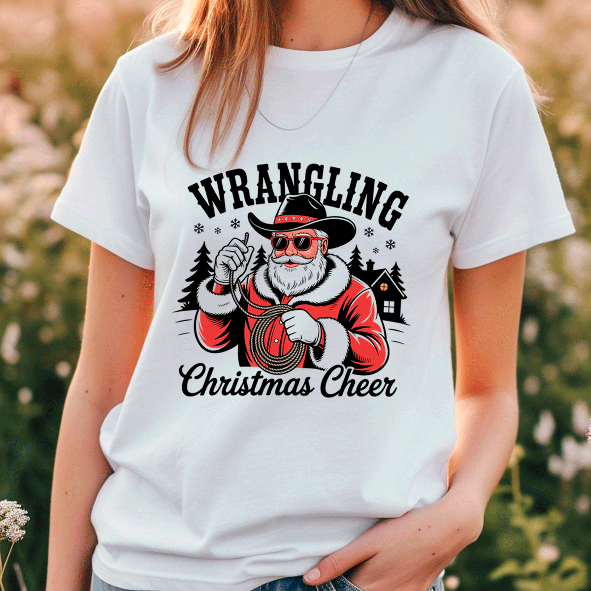 White t-shirt with 'Wrangling Christmas Cheer' design featuring a Santa Claus-like character.