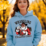 Person wearing a light blue hoodie with 'Wrangling Christmas Cheer' design outdoors.