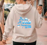 Person wearing a light gray hoodie with a humorous text design, holding a coffee cup.