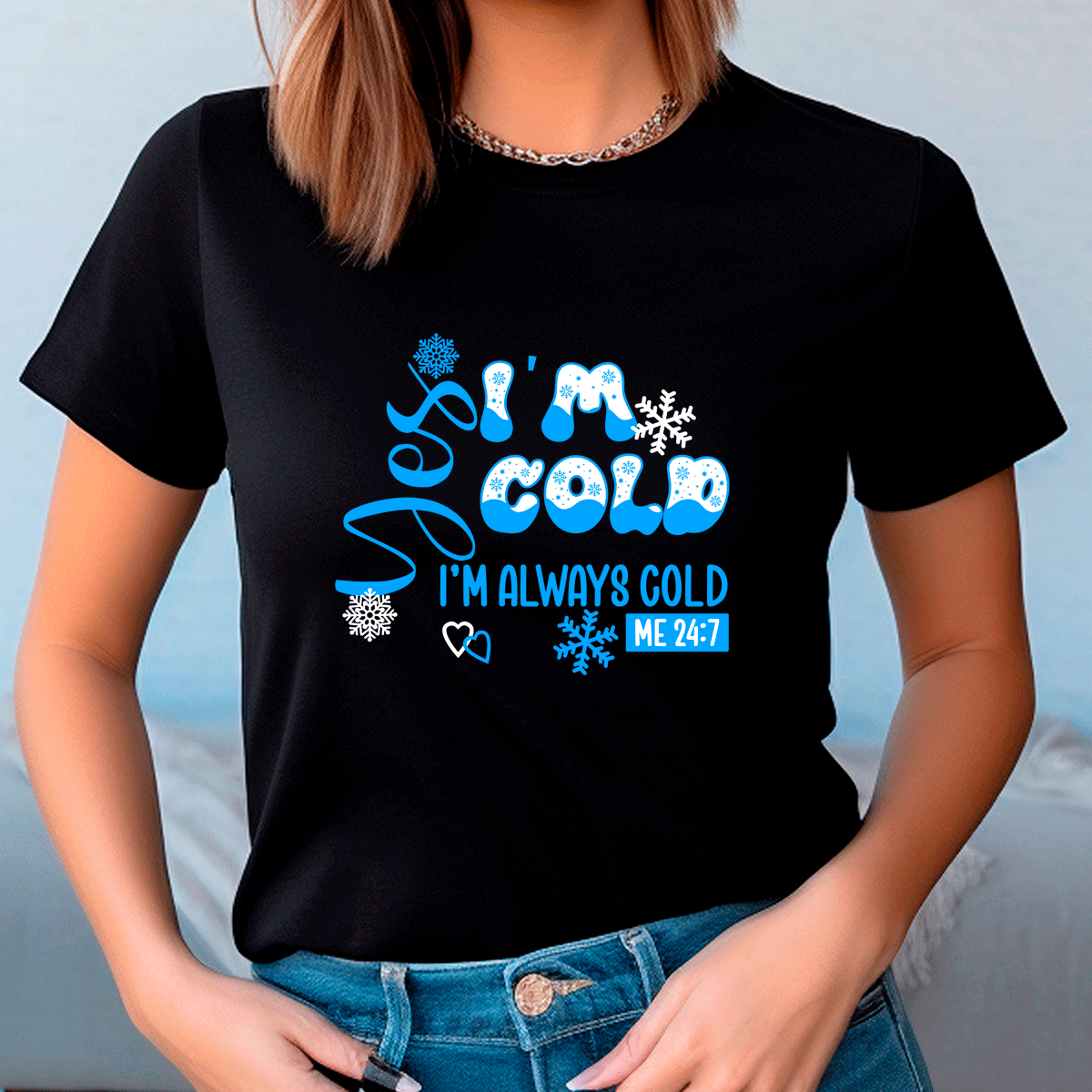 Person wearing a black t-shirt with blue text and snowflake graphics.