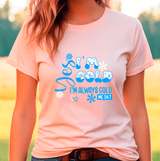 Person wearing a light pink t-shirt with blue text and graphics.