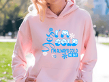 Person wearing a pink hoodie with blue text outdoors