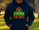 Person wearing a navy hoodie with 'Zombie Patrol' text and logo outdoors.
